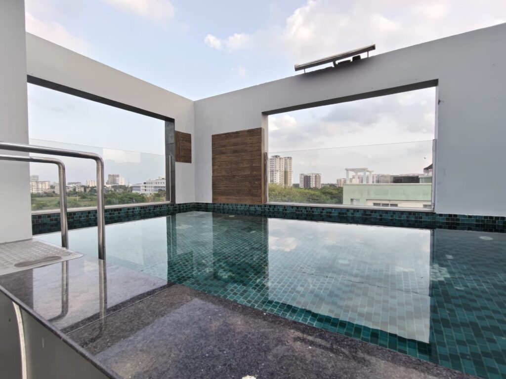 Relax and unwind at the rooftop swimming pool overlooking New Town, Kolkata.

Rooftop swimming pool at WaterView Residency New Town Kolkata